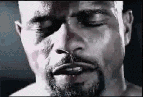a close up of a man 's face with a beard and a black eye .