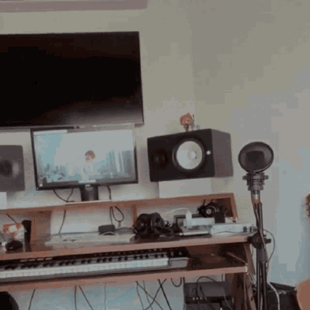 a recording studio with a keyboard and monitor