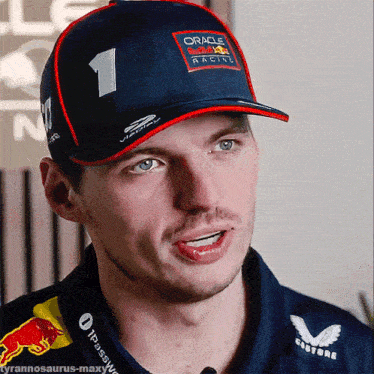 a man wearing a hat that says oracle red bull racing