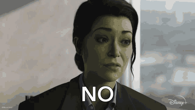 a woman with a green face and the word no on her face