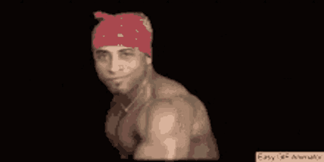 a man with a red bandana on his head is smiling