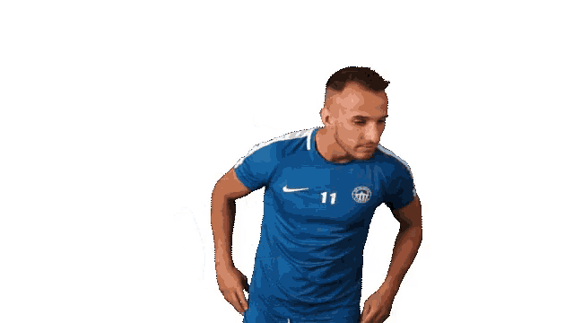 a man wearing a blue shirt with the number 11 on it stands with his hands on his hips