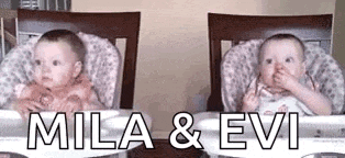 two babies are sitting next to each other in high chairs eating food .