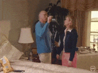 a man and a woman are standing next to each other in a room .