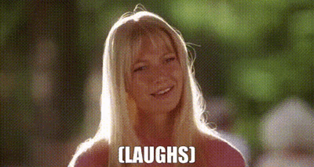 a woman is smiling and laughing with the words `` laughs '' written on her face .