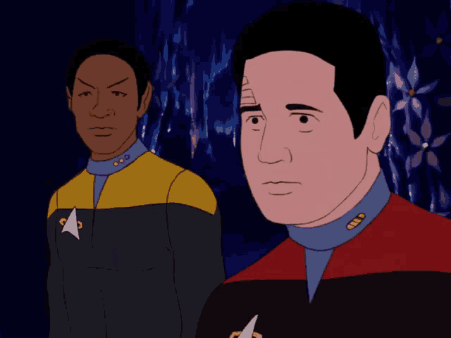a man in a star trek uniform has his hands folded in front of him