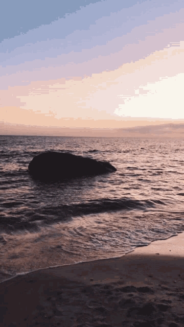 a large rock in the middle of the ocean