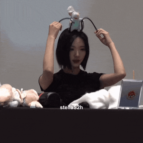 a woman wearing a headband that says stellas2h on the bottom right