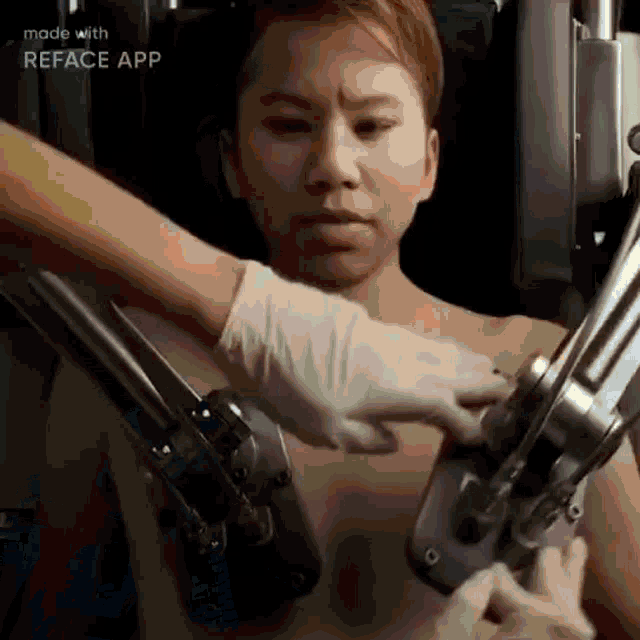 a man is being operated on by a machine with a robotic arm .