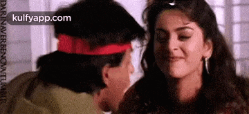 a man is kissing a woman on the forehead in a movie .