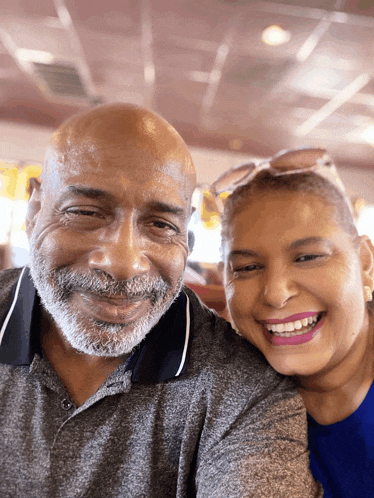 a man and a woman are posing for a picture together