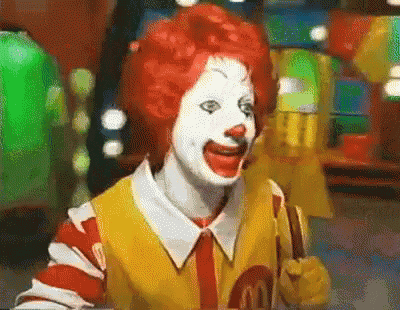 mcdonald 's clown with red hair and white face paint