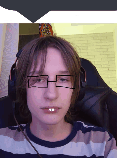 a young man wearing headphones and glasses has a drawing on his face that looks like a tooth