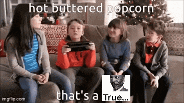 a group of children are sitting on a couch playing a video game while eating hot buttered popcorn .