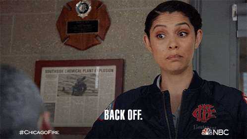 a woman says back off in front of a plaque