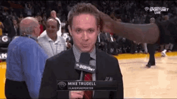 mike trudell is being interviewed by a basketball player