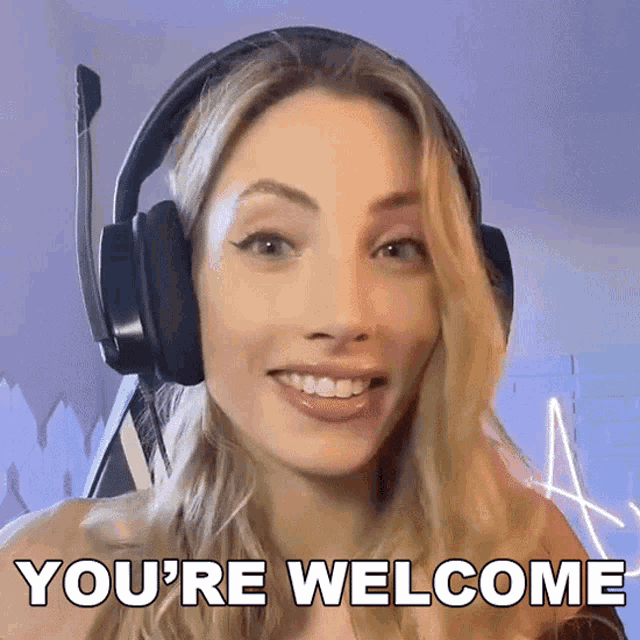 a woman wearing headphones says " you 're welcome " while smiling