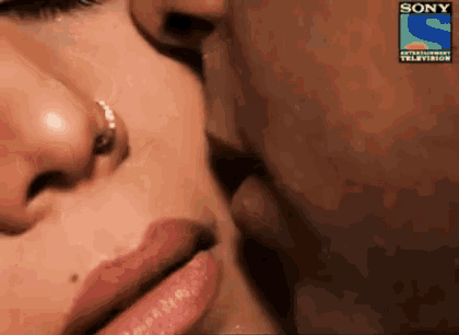 a close up of a man kissing a woman with a sony logo on the bottom