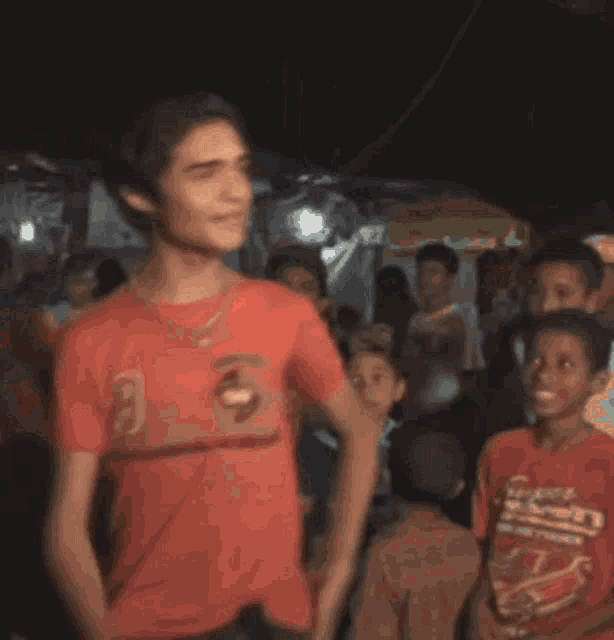 a boy in a red shirt with the number 9 on it is dancing