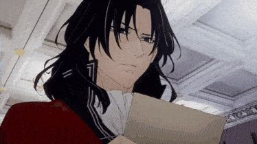 a man with long black hair holds a piece of paper in his hand