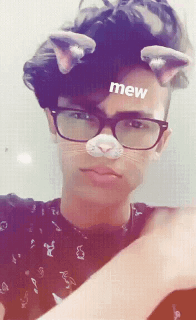 a young man wearing glasses and a cat mask with mew written on his forehead