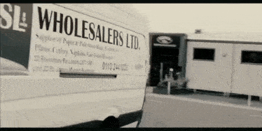 a white van that says wholesalers ltd. on the side