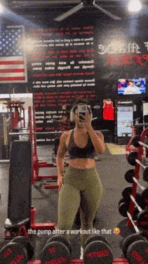 a woman is taking a picture of herself in a gym with dumbbells that say the pump