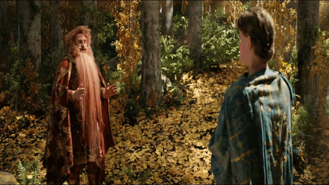 a man with a beard is standing next to another man
