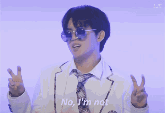 a man wearing sunglasses and a tie says " no i 'm not "