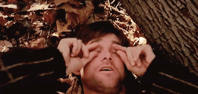 a man laying on the ground with his eyes closed and a watermark that says ' mrs.stuzzyface '