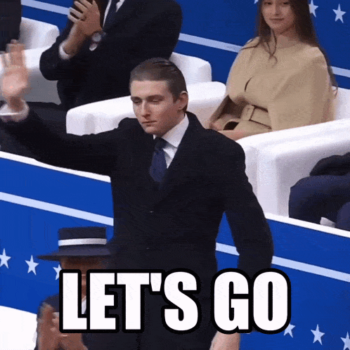 a man in a suit says let 's go in a crowd