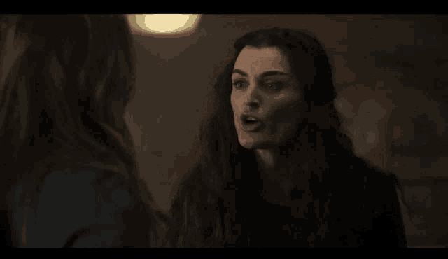 two women with long hair are talking to each other