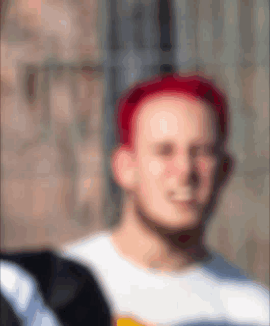 a blurry picture of a man wearing a red hat and a white shirt