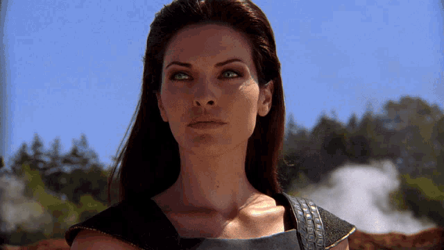 a close up of a woman 's face with green eyes