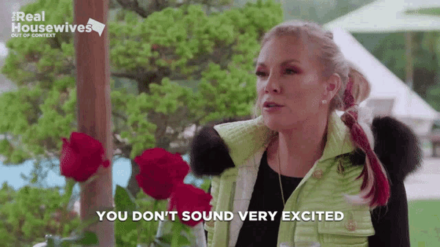 a woman in a green vest says " you don t sound very excited "