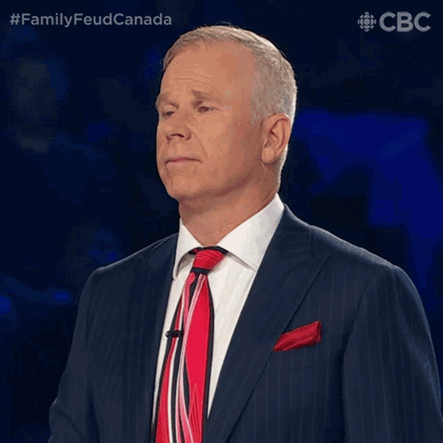 a man in a suit and tie says i apologize in front of a blue background