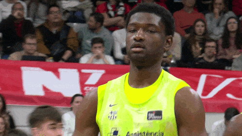 a basketball player stands in front of a banner that says " n7 "