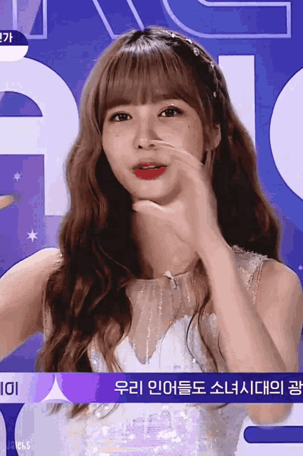 a woman in a white dress with a purple sign that says 101 on it