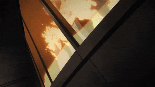 a person is standing in front of a window with a fire coming out of it .