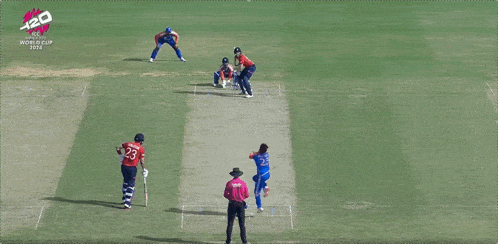 a man in a blue and red india jersey is pointing at something