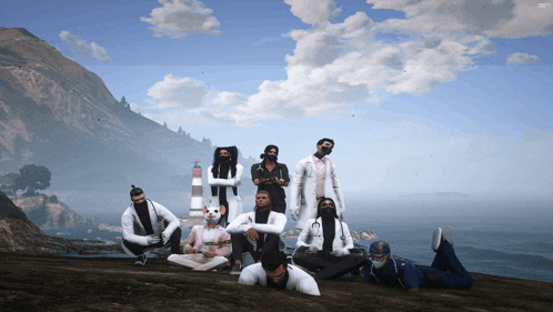 a group of people wearing masks are posing for a picture in front of a lighthouse
