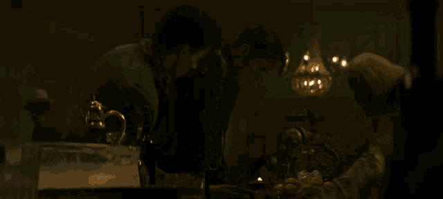 a man in a black vest is drinking from a glass
