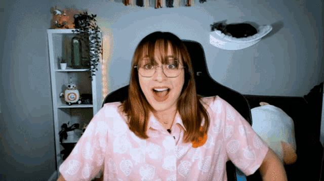 a woman wearing a pink shirt with animal crossing leaves on it
