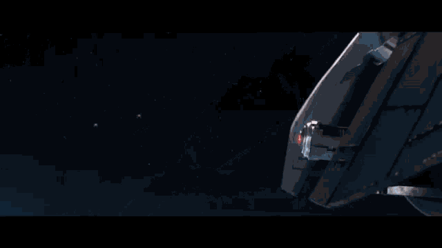 a space ship is flying through space with a red light coming out of it