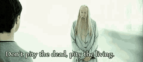 a man with a beard is standing next to another man with the words " don 't pity the dead pity the living "