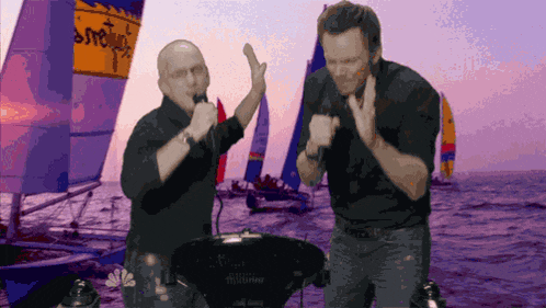 a man singing into a microphone with a sailboat in the background that says ' sydney ' on it