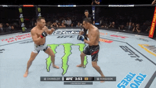 two men are fighting in a ufc ring with a monster on the ground