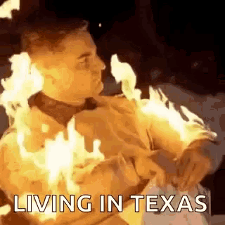 a man is covered in flames and the words living in texas are above him .