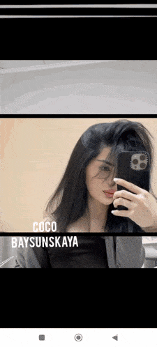 a woman taking a picture of herself in a mirror with the name coco baysunskaya