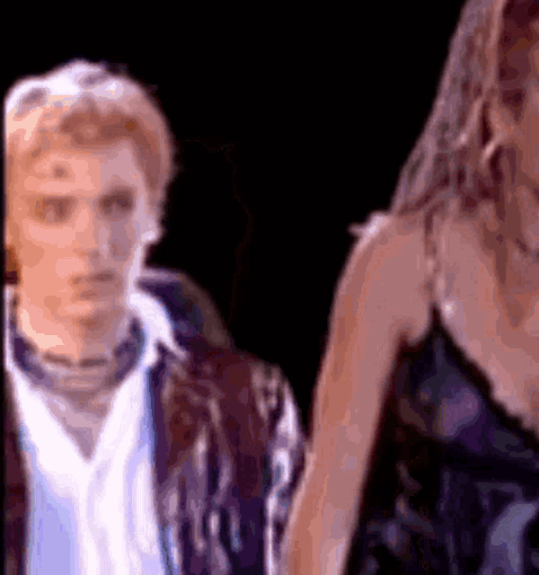 a man and a woman are standing next to each other on a stage .
